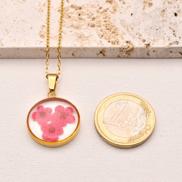 Pink blossom in round pendant