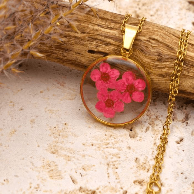 Pink blossom in round pendant
